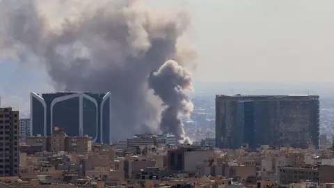 Plumes of smoke rise following reported explosions in Tehran on March 1, 2026