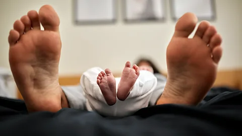 Adult and baby feet side by side (Credit: Getty Images)