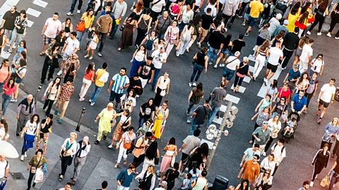 Aerial view of crowds of people crossing the street in Madrid, Spain (Credit: Getty Images)