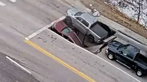CCTV shows moment cars engulfed by sinkhole