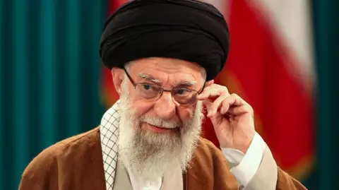 Ayatollah Ali Khamenei adjusts his glasses in a 2024 photograph
