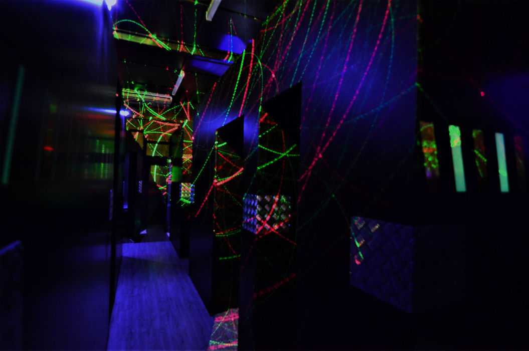 A dark corridor in the maze, lit by colourful laser light