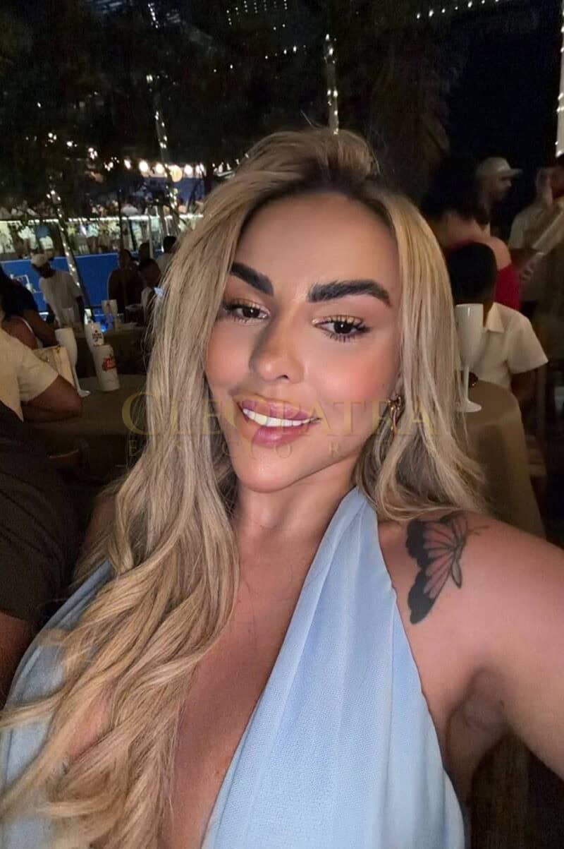 Elegant blonde woman at Cleopatra Escorts London event.