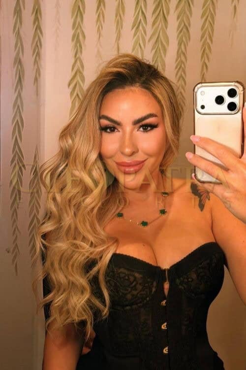 Elegant London escort woman with blonde hair and black lace.