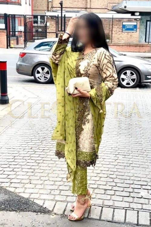 South Asian woman in traditional dress with clutch in London.