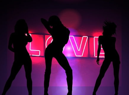 A depiction of a strip club with 3 girls dancing