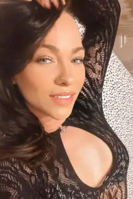 Close up of a very pretty dark-haired Romanian girl in a black lace top