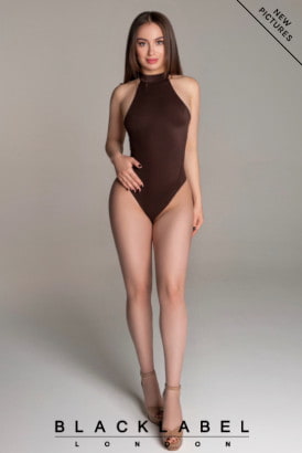 Fair skinned young beautiful girl in a sexy swim suit and heels