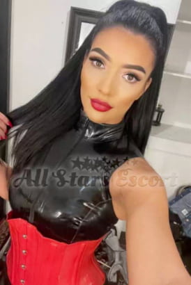 Young dark-haired Hungarian girl in red lingerie smiling brightly